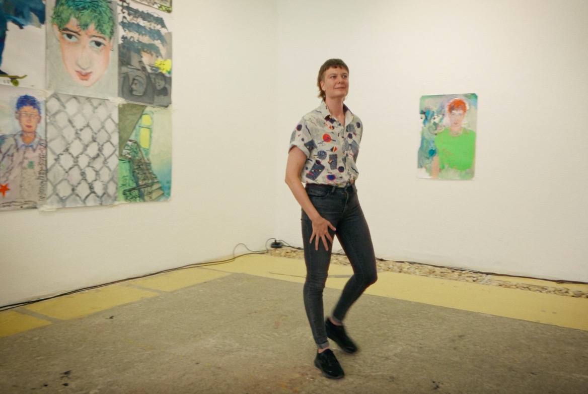 Dancer in Jeans and colorful shirt surrounded by drawings that resemble the performer 