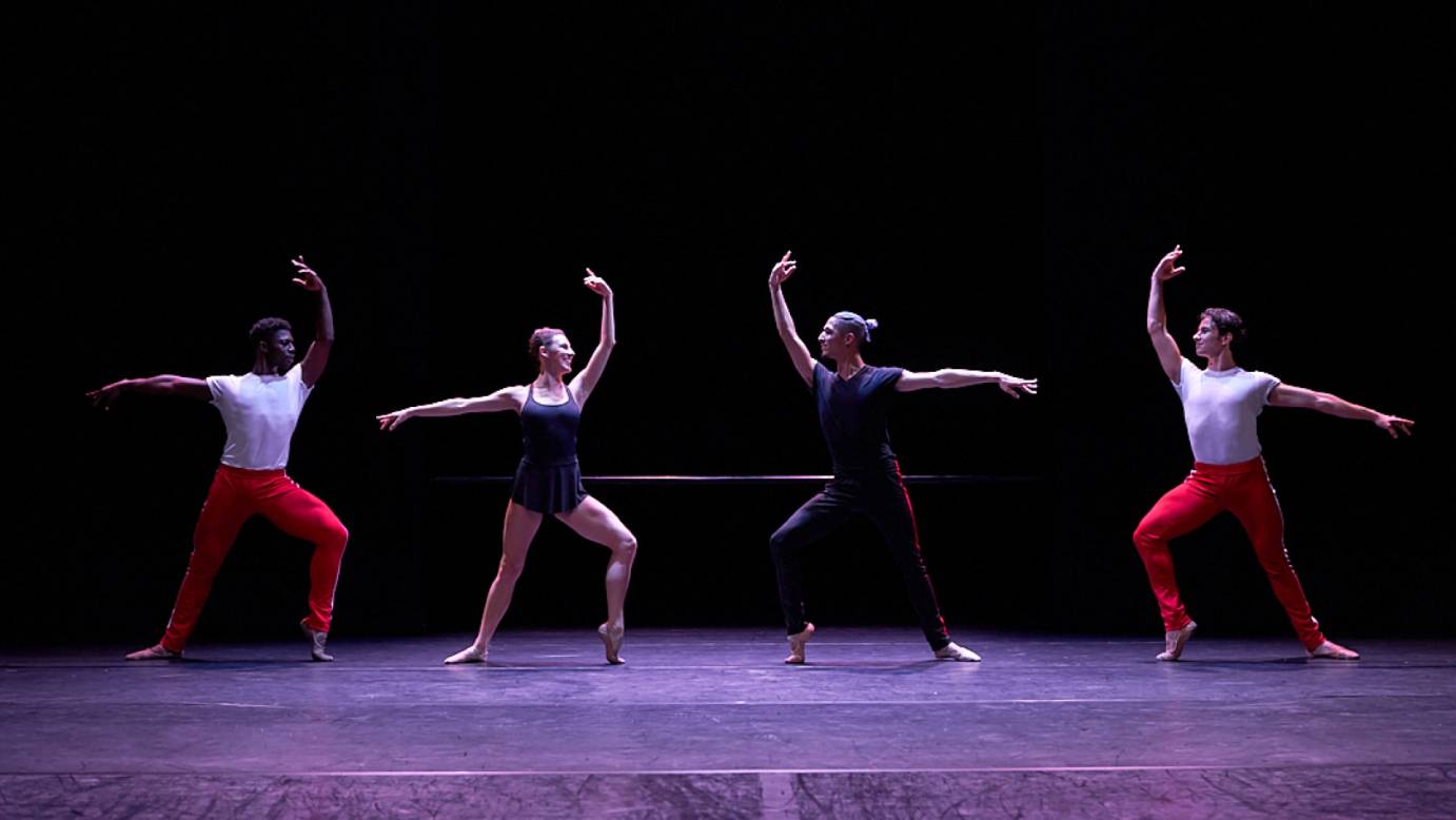 The four dancers from the barre project mirror two by two a high third position with one foot popped in forced arch