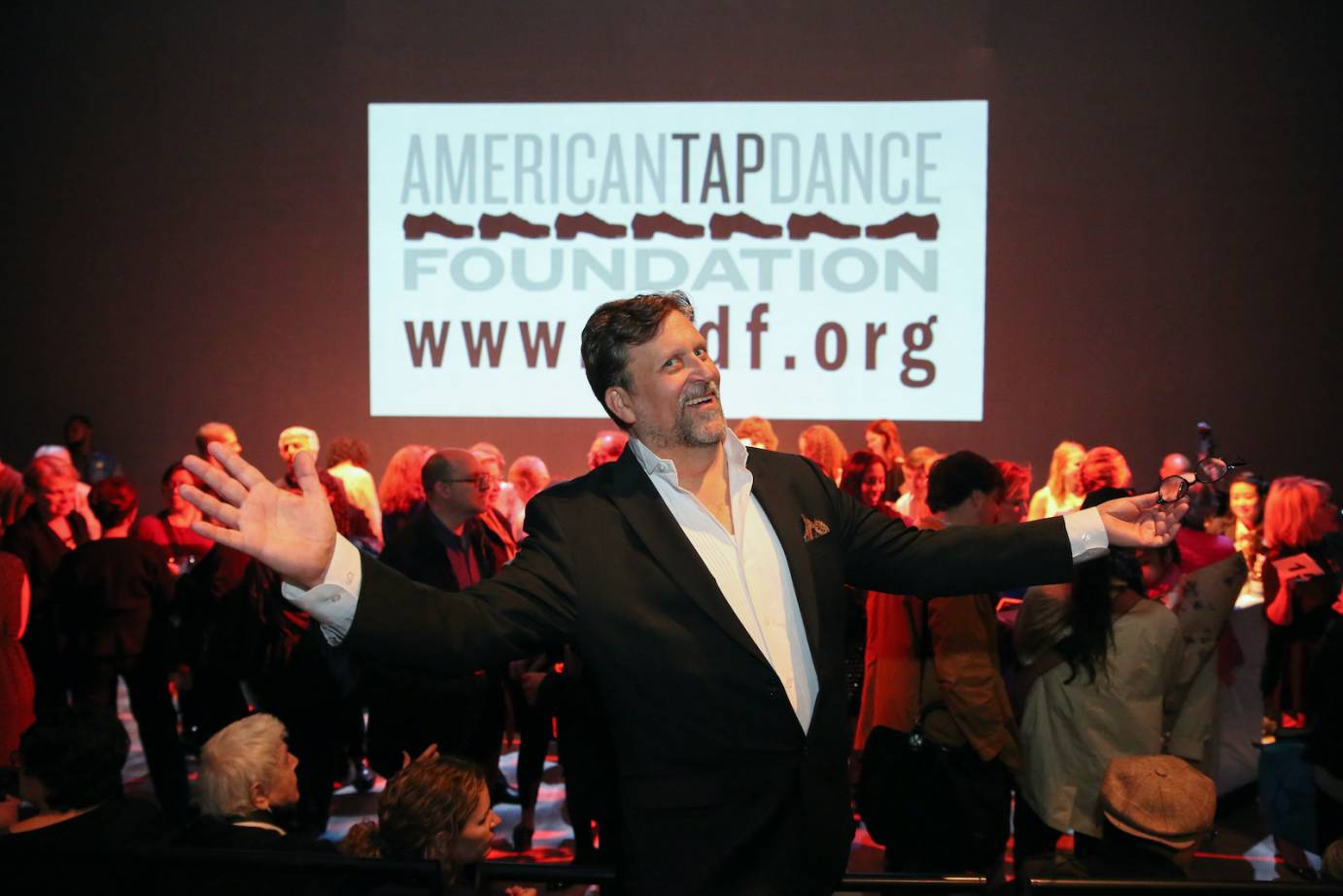 Tony Waag mugs for the camera as a true showman right in front of a sign for the American Tap Foundation 