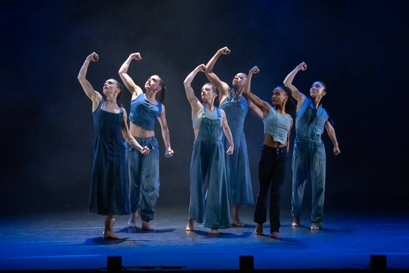 6 female dancers standing with raised fists