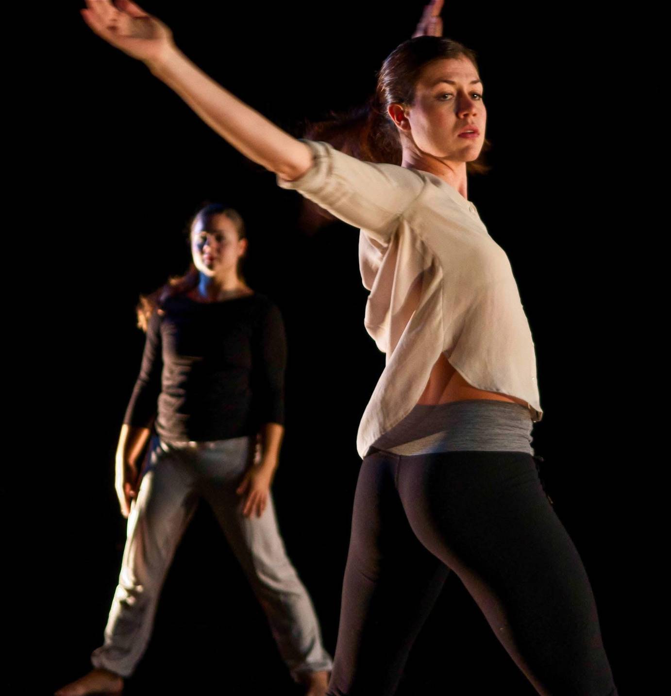 Alison Manning in foreground swinging arms with another women in background who is  holding her shoulder i