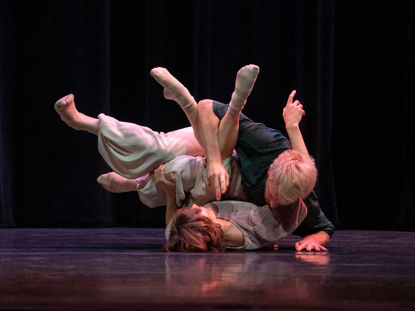 The limbs of Alice Klock and Florian Lochner are knotted together with Klock lying on the floor.