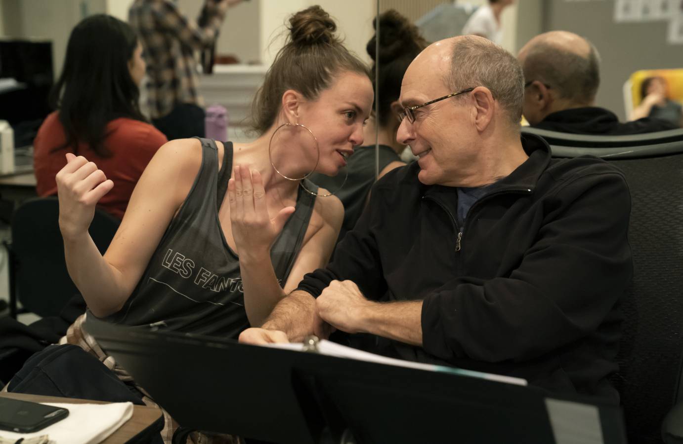 Michelle Dorrance chats with James Lapine during rehearsal. Both wear animated expressions