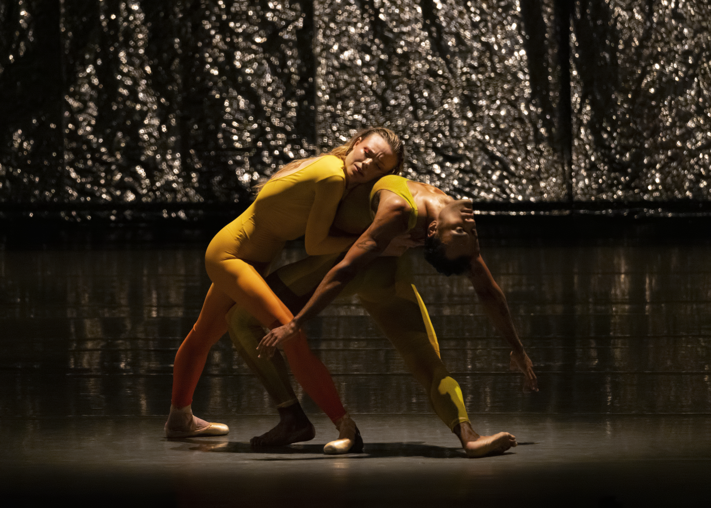 Sara Mearns lays her head on Taylor Stanley's stomach. He is arched in a deep backbend.